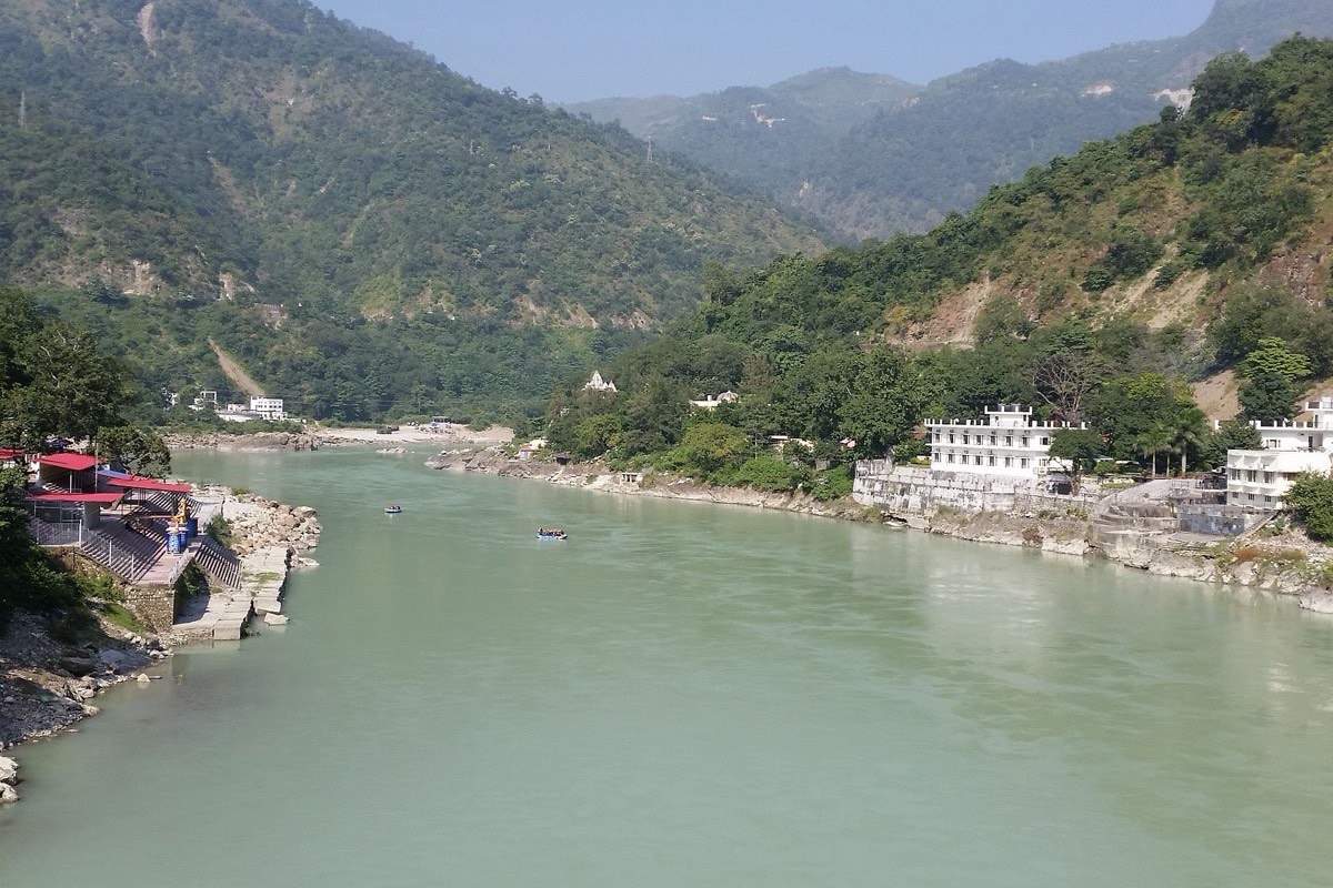 The Ganges river flowing through the Himalayan foothills at Rishikesh, India